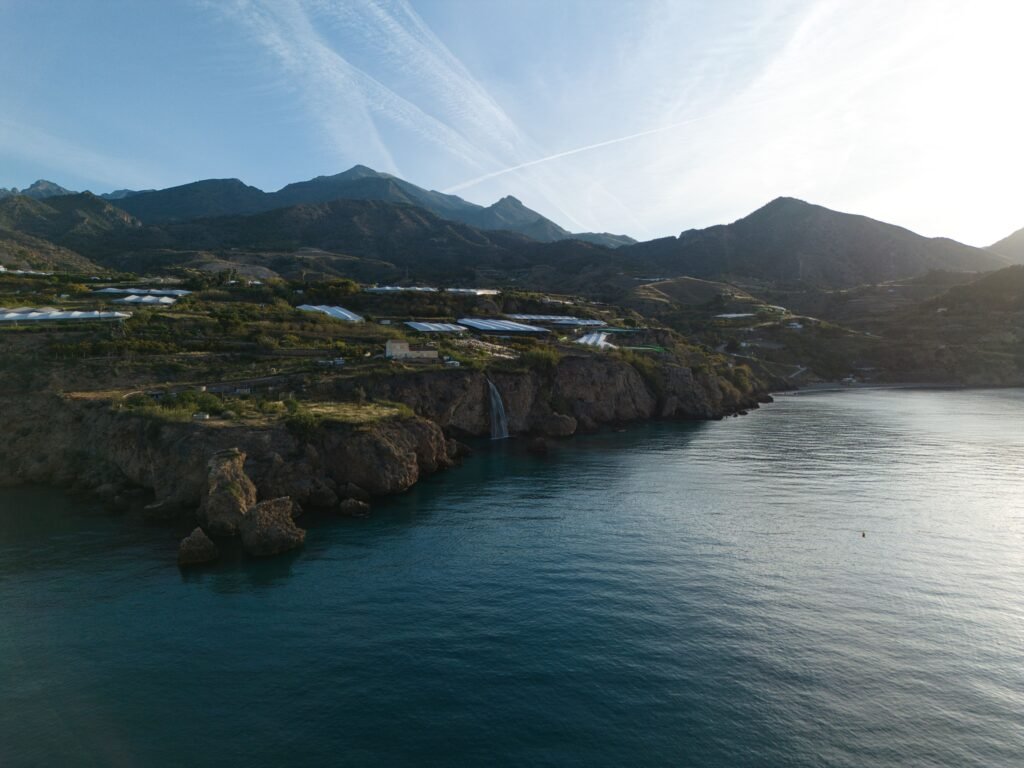 Captivating coastal landscape in Maro featuring mountains, cliffs, and calm waters, perfect for nature lovers.
